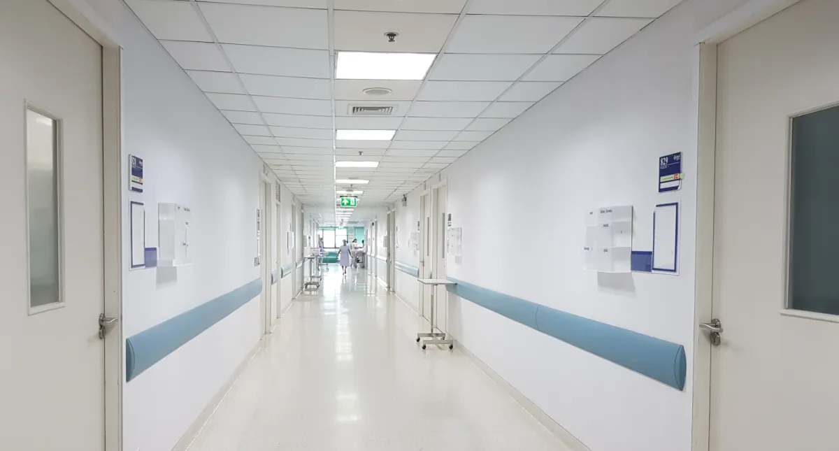 Hospital corridor in a clinical ward, representing the urgent hospital treatment required for serious infections such as meningitis.
