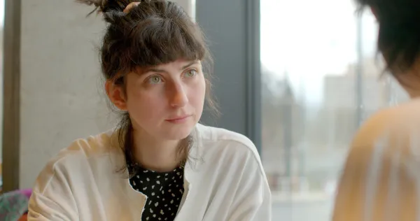 A colleague listening during a private one-to-one conversation.