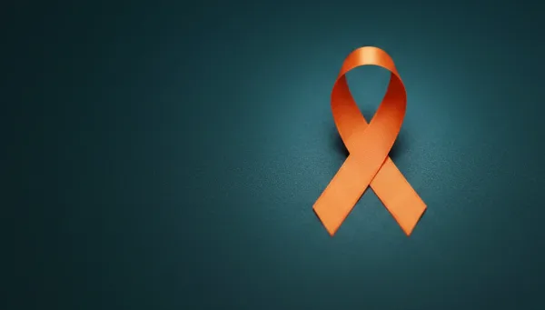 Orange awareness ribbon on a dark teal background